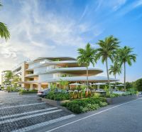 Výstavba bytů v Phuketu s moderní architekturou, obklopená palmami a parkovací plochou.