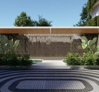 Exteriér ve výstavbě bytů v Phuketu, s listím a dekorativní stěnou pod přístřeškem.