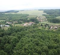 Letecký pohled na zemědělské a lesní pozemky v okolí Trebušovců s vesnickým osídlením.