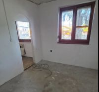 Nevyhotovená stěna a okna v pokoji 3pokojového bytu s možnou renovací.