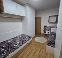 Dětský pokoj s podlahou s dřevěným dekorem a vestavěnými skříněmi v 3-pokojovém bytě.
