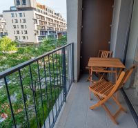 Balkon 1-pokojového bytu na ulici Zuzany Chalupové, Bratislava - Petržalka s dřevěným nábytkem.