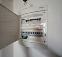 Elektrická rozvodná skříň v 2-pokojovém bytě s otevřenými dvířky a zásuvkou.