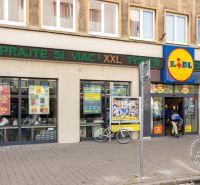 Lidl na Grösslingově ulici v Bratislavě - Staré Město s kolemjdoucími lidmi a kolem.
