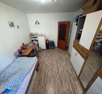 Pokoj se skříní a pracovním stolem v 2pokojovém bytě s podlahou s dřevěným dekorem.