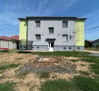 Dvoupatrová budova v Telincích s dvorem, trampolínou a houpačkou.