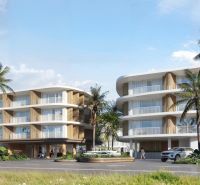 Výstavba bytů v Surat Thani s palmovými stromy a moderní architekturou.