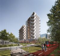 Novostavba s balkony, cyklista a tramvaj na Mlynských Nivách v Bratislavě-Ružinově.