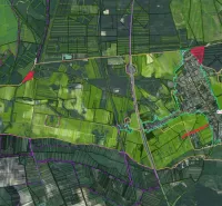 Letecký pohled na zemědělské a lesní pozemky v obci Závod se silniční infrastrukturou.