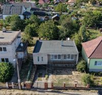 Letecký pohled na řadu rodinných domů v Ivance pri Nitre se zahradami a stromy.