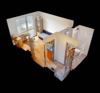 3D pohled na garsonku s podlahou s dřevěným dekorem a zařízením.