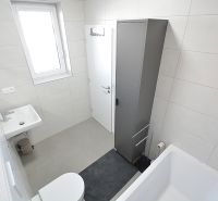 Koupelna v 3-pokojovém bytě s vanou, umyvadlem a skříňkou.