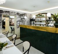 Stylový bar s dekorativními prvky a stoly v obchodních prostorách.