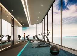 Posilovna s výhledem na moře při výstavbě bytů s moderním zařízením.