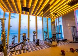 Fitness centrum s výhledem na moře a moderním vybavením v rámci výstavby bytů.