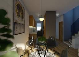 Jídelní stůl se židlemi, schodiště a kuchyň ve 4-pokojovém bytě.