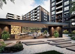 Výstavba bytů v Pattayi, moderní architektura se zelení a venkovními posezeními.