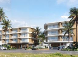 Výstavba bytů v Surat Thani s palmovými stromy a moderní architekturou.