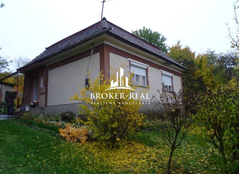 Rodinný dům obklopený zelení a keři, Fony.