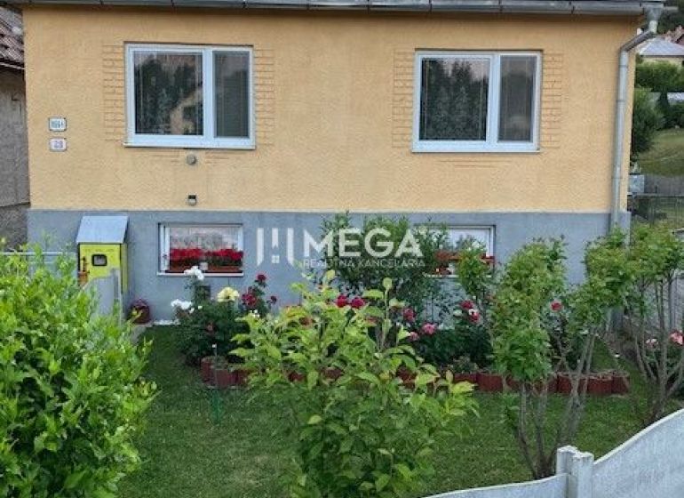 Rodinný dům na Jesenského v Snině s pěkně upravenou zahrádkou a květinami.