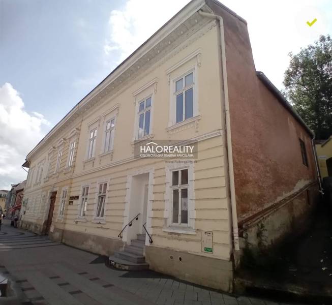 Historická budova využívaná jako obchodní prostory na ulici v Ružomberku.