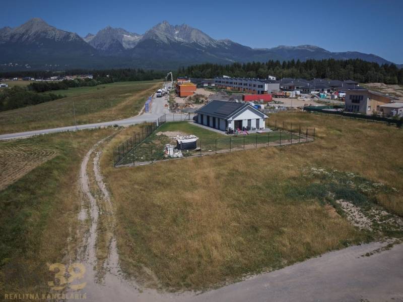Pozemky na bydlení v Mlynici s výhledem na Tatry, venkovský dům a stavby v pozadí.