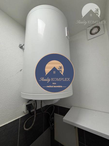 Elektrický bojler v koupelně 1-pokojového bytu zobrazující detaily instalace.
