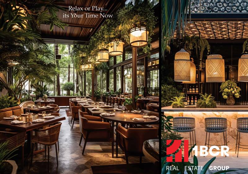 Luxusní interiér restaurace s dřevěnými stoly, židlemi a rostlinami. Výstavba bytů.