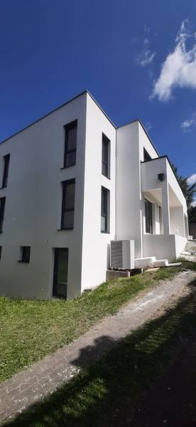 Vila v Hainburgu an der Donau s bílou fasádou a minimalistickým designem.