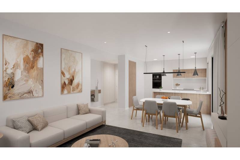 Obývací pokoj rekreačního apartmánu s pohovkou, jídelním stolem a kuchyňským koutem.