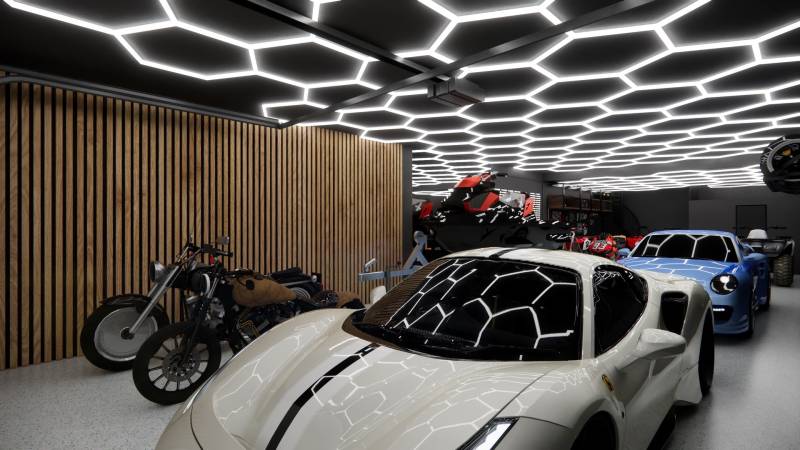 Obchodní prostory s automobily, motorkami a unikátním osvětlením stropu v garáži.