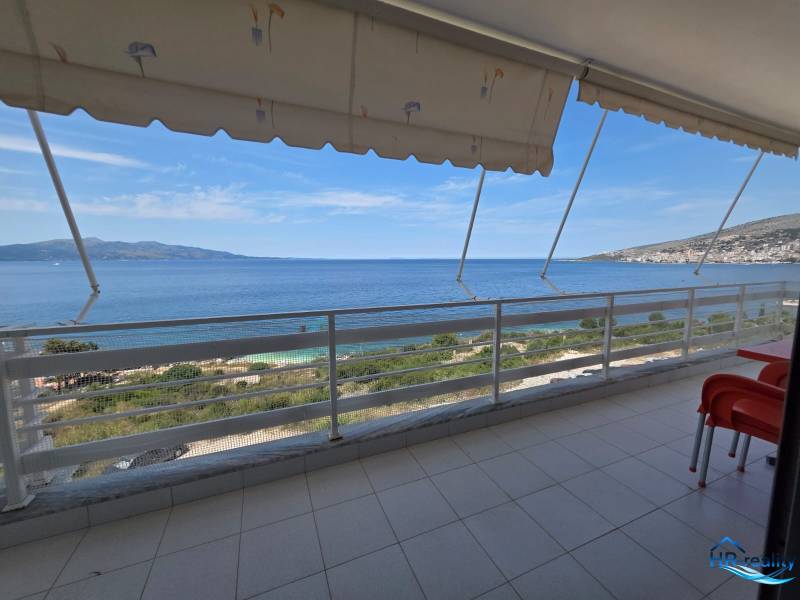 Balkon rekreačního apartmánu v Sarandë s výhledem na moře a okolní krajinu.