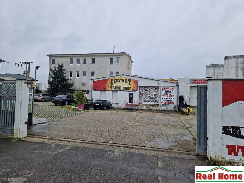 Budova Convoy Truck Shop na ulici Šamorínska, obklopená zaparkovanými auty u skladu a hal.
