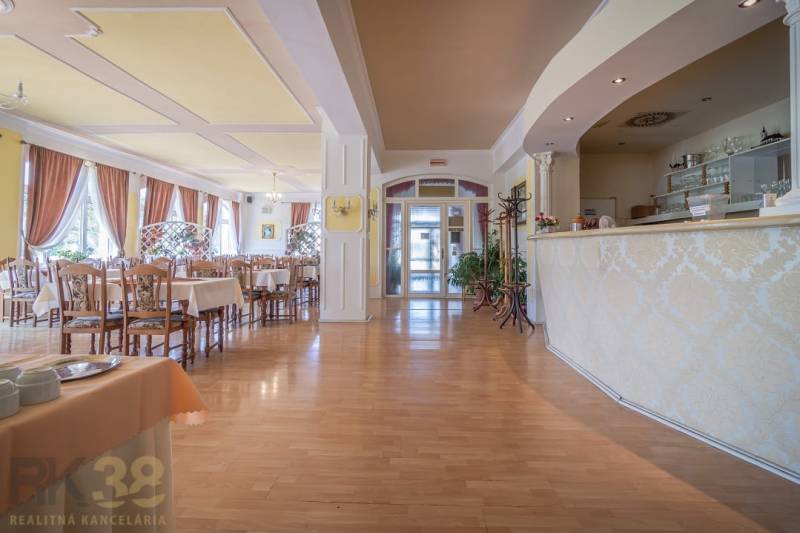 Interiér hotelů a penzionů s restaurací, podlaha s dřevěným dekorem, dekorativní závěsy.