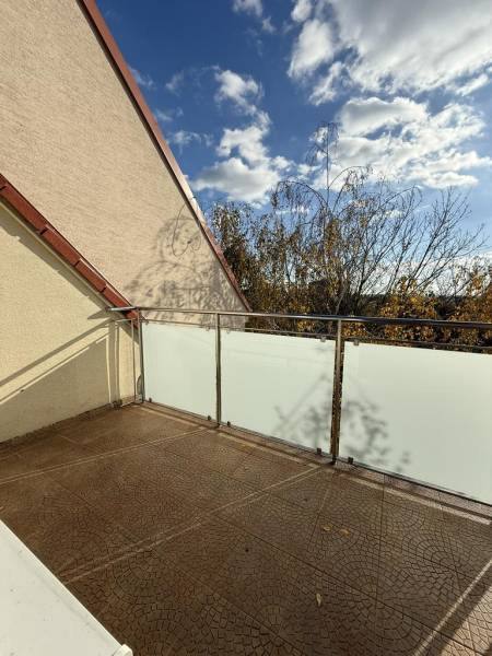 Balkon 4-pokojového bytu na Pekníkově ulici v Pezinku s výhledem na koruny stromů.