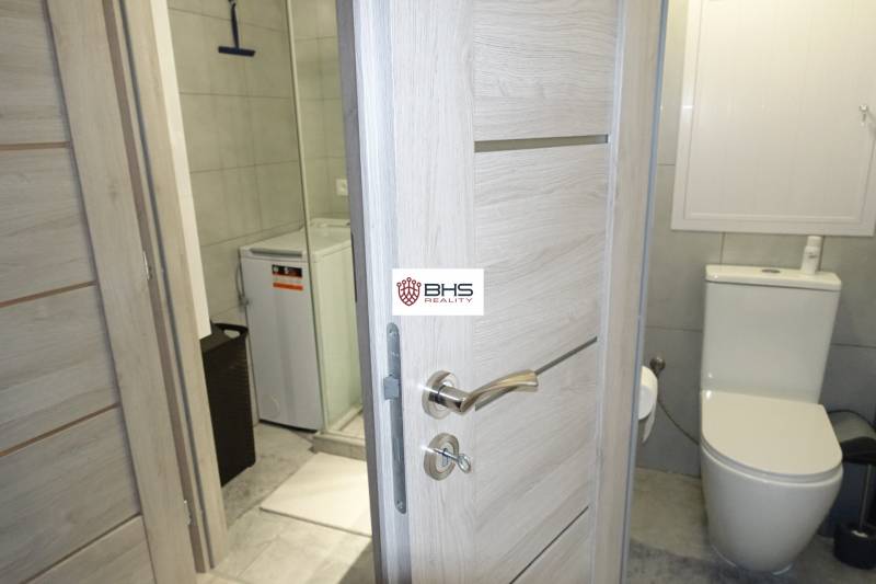 Koupelna v 3-pokojovém bytě se sprchou, pračkou a toaletou.