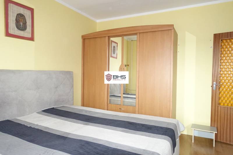 Ložnice s postelí, šatní skříní a dekorací ve 3-pokojovém bytě.