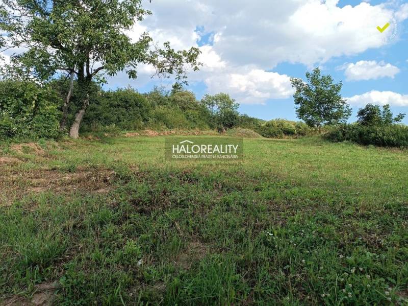 Pozemek na bydlení v Čerhově obklopený zelení a modrou oblohou.