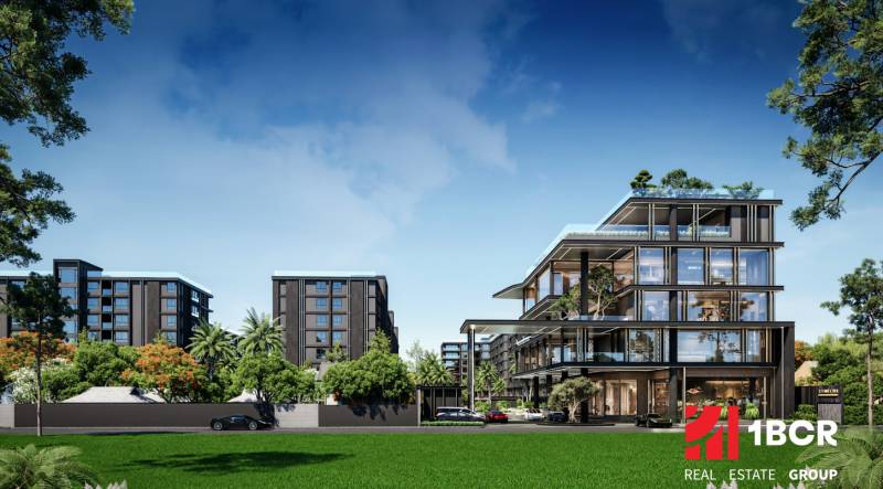 Výstavba bytů v Pattayi obklopená zelení, moderní budovy a auta na pozadí.