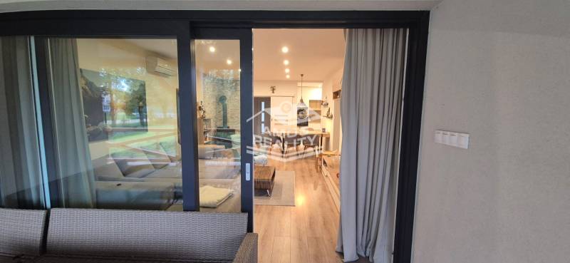 Interiér rodinného domu s podlahou s dřevěným dekorem a pohodlným sezením.