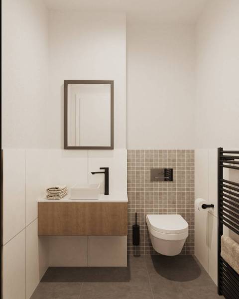 Koupelna se závěsným WC, umyvadlem, topením a zrcadlem, s designovými dlaždicemi.