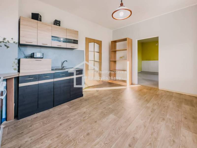 Kuchyně v rodinném domě s podlahou s dřevěným dekorem a světlým interiérem.