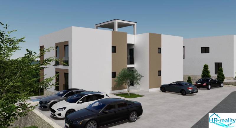 Rekreační apartmán v Ciove se zaparkovanými auty a okolní zelení.