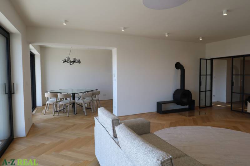 Obývací pokoj 4pokojového bytu s krbem a podlahou s dřevěným dekorem.