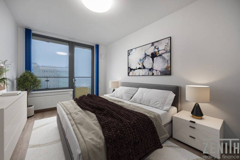 Ložnice v 2-pokojovém bytě s pohodlnou postelí, obrazem a lampou na nočním stolku.