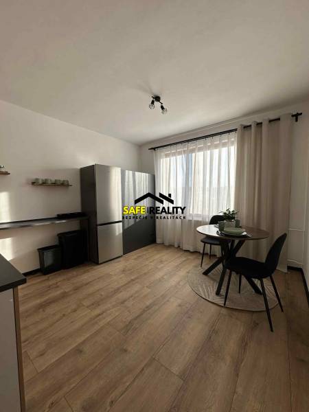 Kuchyně s podlahou s dřevěným dekorem a stolem v 1-pokojovém bytě.