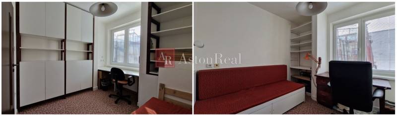 V rodinném domě jsou bílé skříňky, pracovní stůl a červená sedačka.