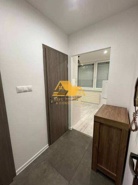 Interiér 1-pokojového bytu s dlažbou a podlahou s dřevěným dekorem.