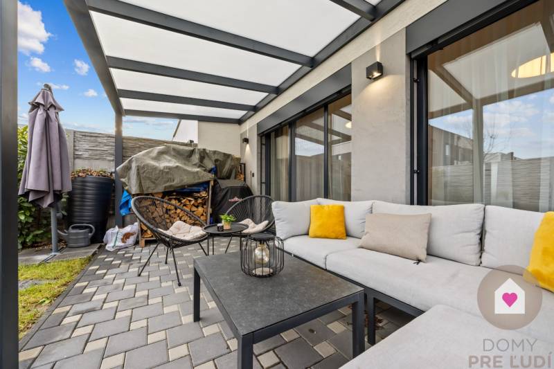 Venkovní posezení s pohovkou a židlemi u 4pokojového bytu na Topoľové ulici v Rovince.