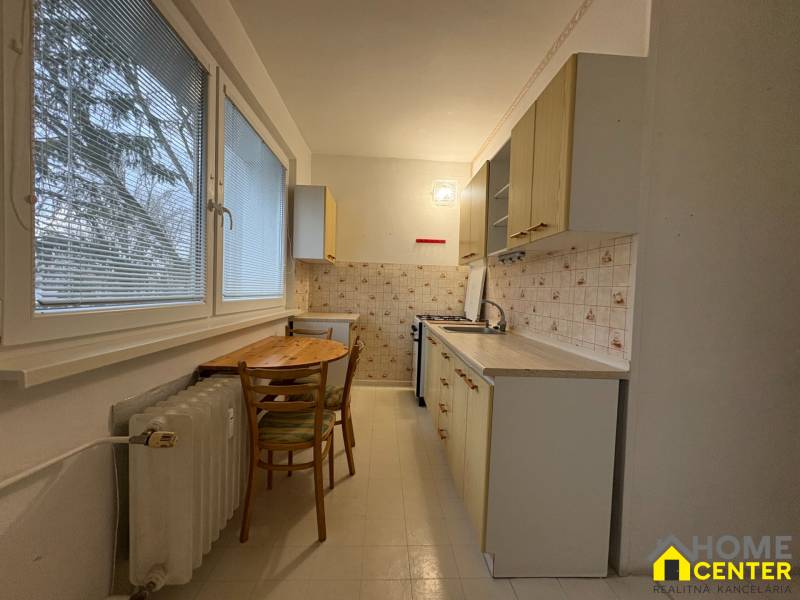 Kuchyně v 3-pokojovém bytě s jednoduchým zařízením a okny s výhledem.